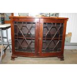 A 19th Century cross banded and astragal glazed bow fronted cabinet
