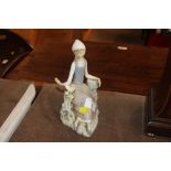 A Lladro porcelain figure of a reclining girl with