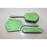 A silver and enamelled part dressing table set