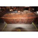A large antique oak coffer with four panel front
