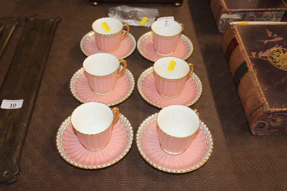 Six pink Royal Crown Derby coffee cups and