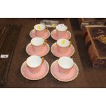 Six pink Royal Crown Derby coffee cups and