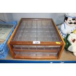 A glass two drawer specimens chest