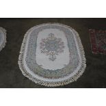 An approx. 5'7" x 3'7" oval floral patterned wool