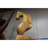 A carved wooden horse bust