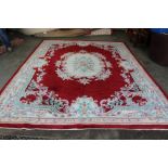 An approx. 14'3" x 10' floral patterned wool rug