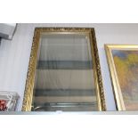 A gilt framed bevelled edge oblong wall mirror