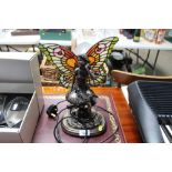 A figural decorated table lamp