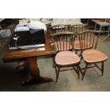 An Ercol extending dining table and a set of four