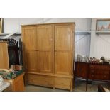 An oak triple wardrobe fitted two drawers