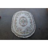 An approx. 4'6" x 3'1" oval floral patterned wool