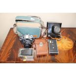 A camera bag together with a Canon camera; Zenit c