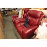 A pair of red leather upholstered electric reclini