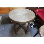 An Eastern brass topped tray table