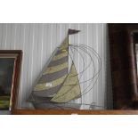 A piece of metal wall art in the form of a boat