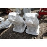 A pair of concrete garden statues in the form of l