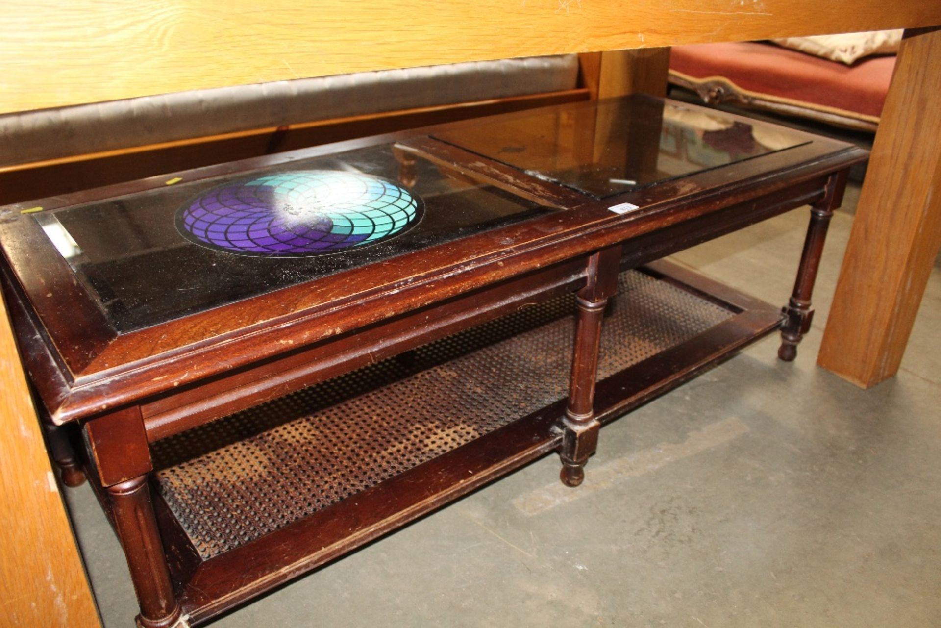A wooden and glass topped coffee table