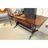 A sofa table fitted two drawers raised on stretche