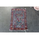 An approx. 2'5" x 1'8" floral patterned rug AF