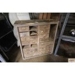 A wooden workshop haberdashery cabinet