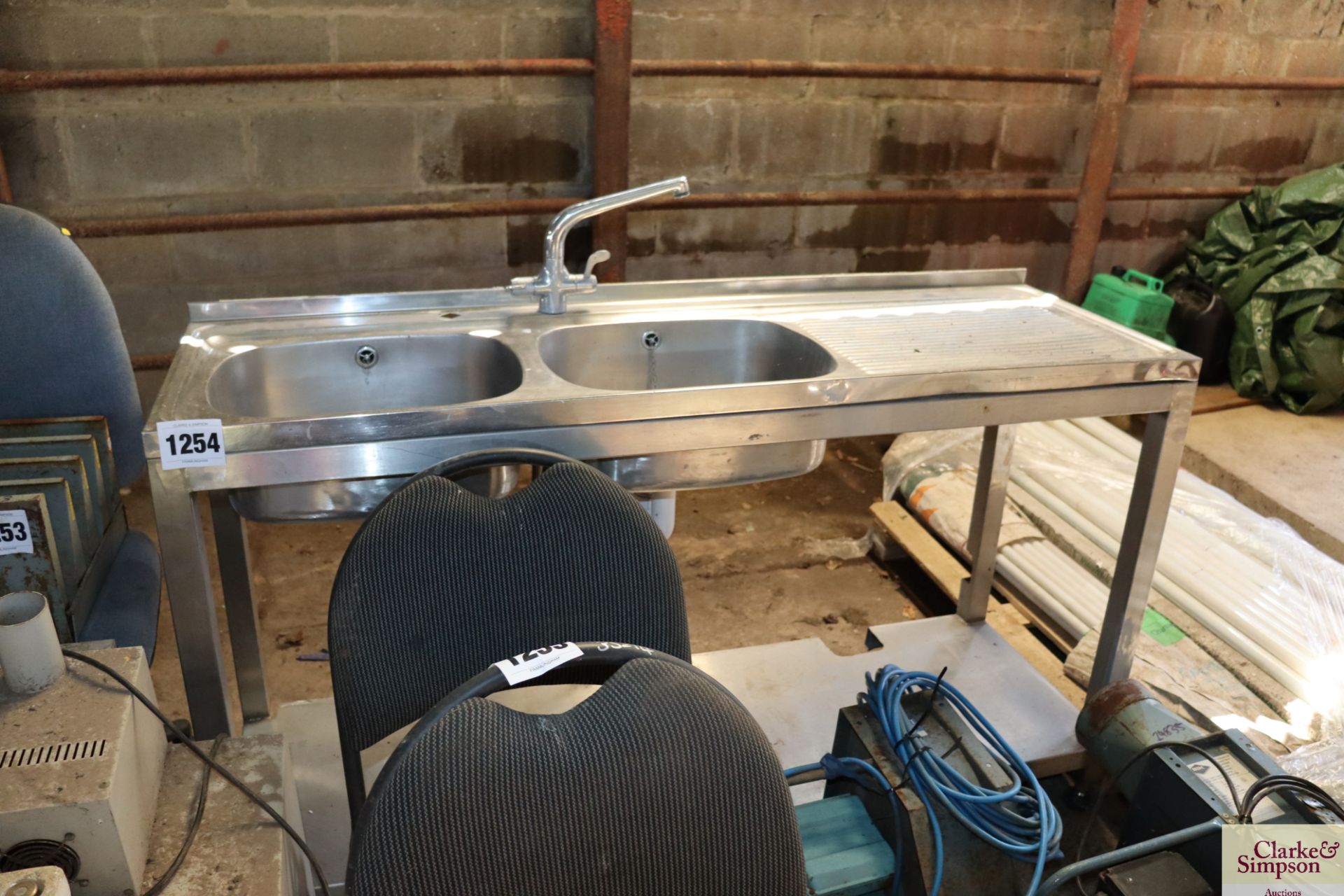 Stainless steel twin sink table with tap.
