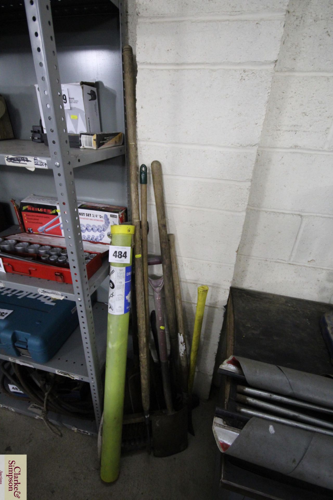 Quantity of long handled tools and unused drain rods.