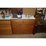 A teak chest of two short and three long drawers