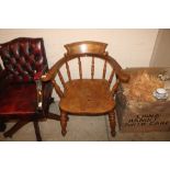 A Victorian smokers bow elbow chair with pollard s