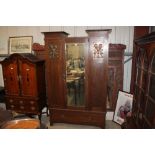 An Arts & Crafts style oak wardrobe with copper pa