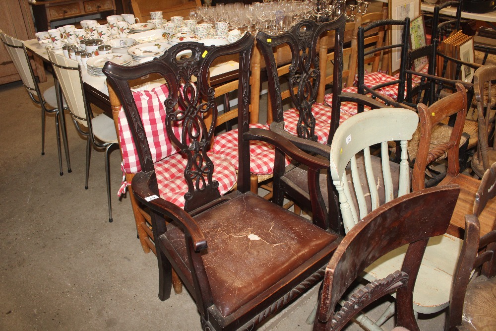 A pair of mahogany Chippendale style elbow chairs