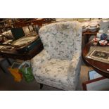 A buttoned upholstered wing back easy chair