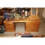 A stripped pine pedestal dressing table fitted six