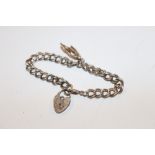 A silver charm bracelet with padlock clasp