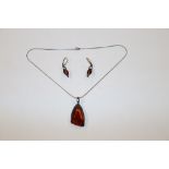 A 925 amber coloured pendant on chain and pair of