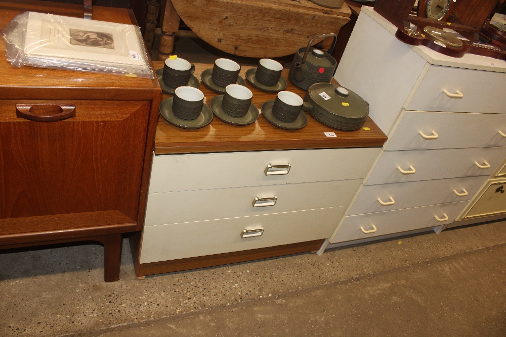 A laminate three drawer chest