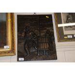 An antique carved oak panel depicting a prisoner working a horse mill and a guard standing by with