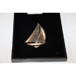 A brooch in the form of a sailboat
