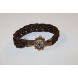 An antique hairwork and yellow metal bracelet