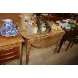 An antique pine drop leaf dining table