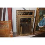 Two decorative gilt framed bevel edged wall mirror