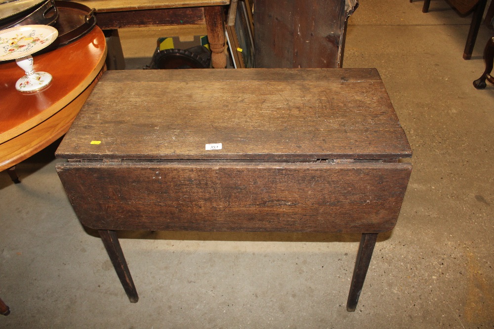 An antique oak drop leaf table