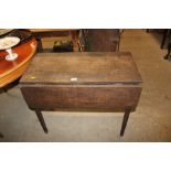 An antique oak drop leaf table