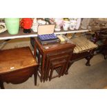 A nest of four carved hardwood occasional tables