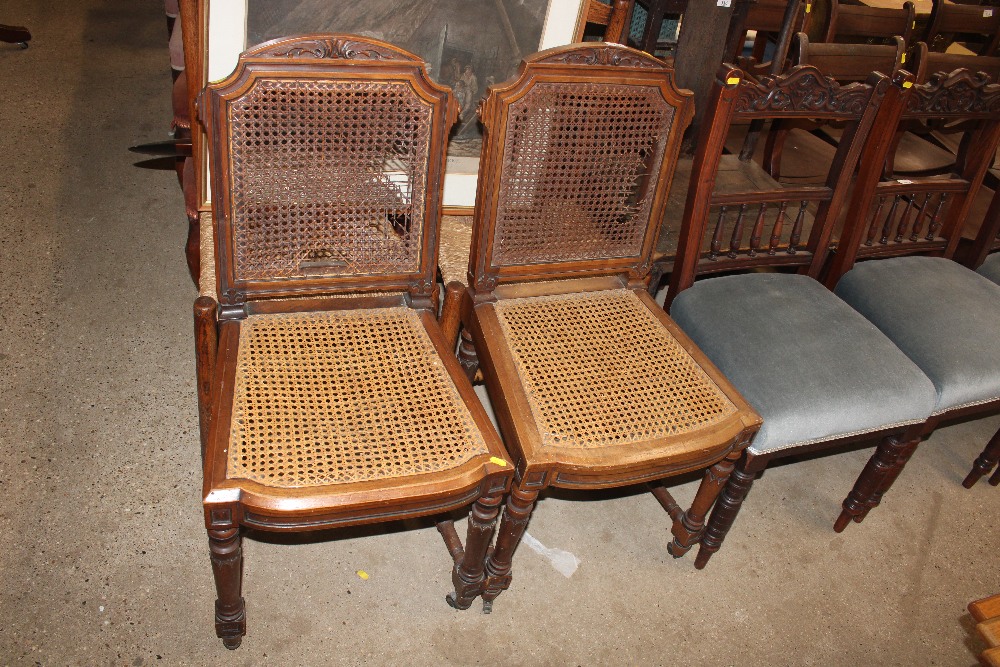 A pair of French walnut cane panelled side chairs