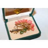 A gilt metal coral and jade set brooch