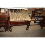 A carved mahogany music stool