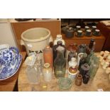 A collection of various stoneware bottles, a bread