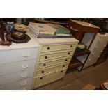 A laminate chest of five graduated drawers