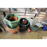 A quantity of plastic plant pots, tubs and a garde