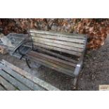 A wooden and metal garden two seater bench AF